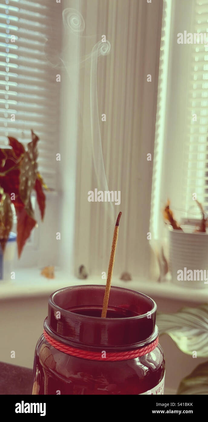 Burning scented incense stick creating spirals in its scented smoke 🌀 Stock Photo Alamy