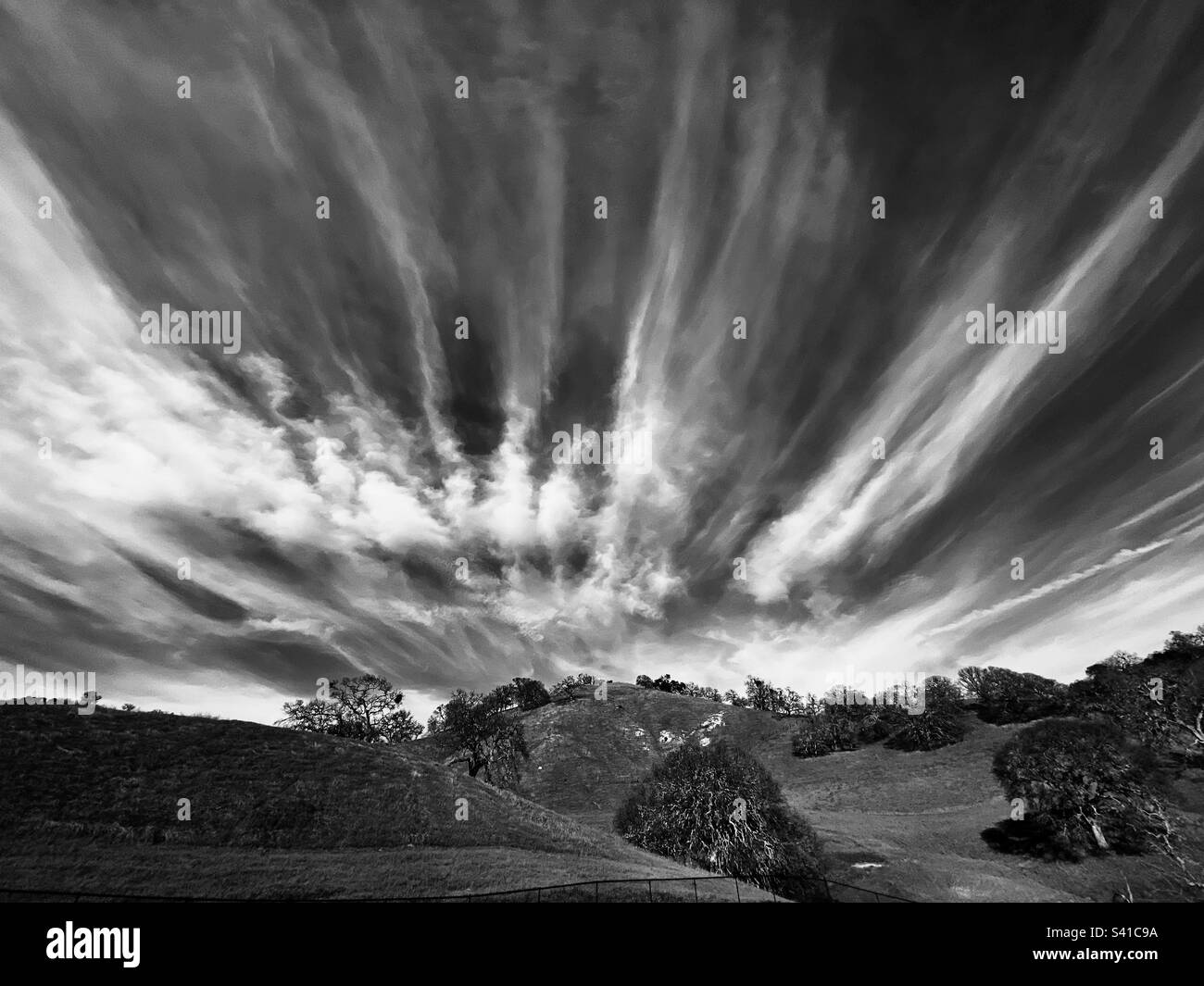 Cloudscape over foothills, in black and white Stock Photo
