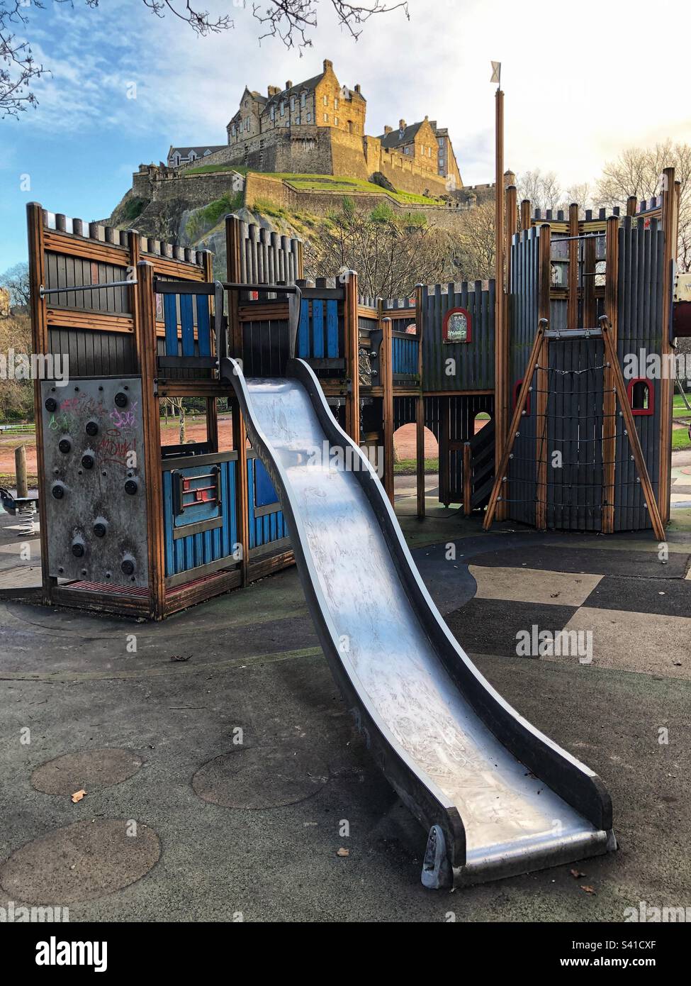 Kids playground chute in Princes Street Gardens with Edinburgh Castle as a backdrop - Smartphone Captured Stock Image