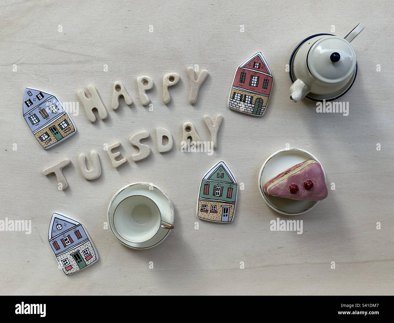 Happy Tuesday composition with wooden letters and miniature objects - Smartphone Captured Stock Image