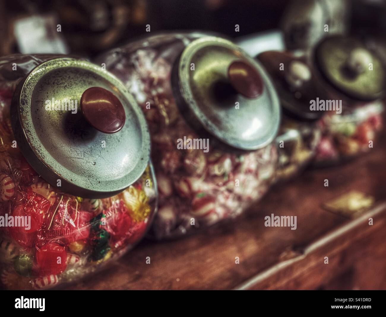 Antique candy jars on a wooden counter in an old General Store - Smartphone Captured Stock Image