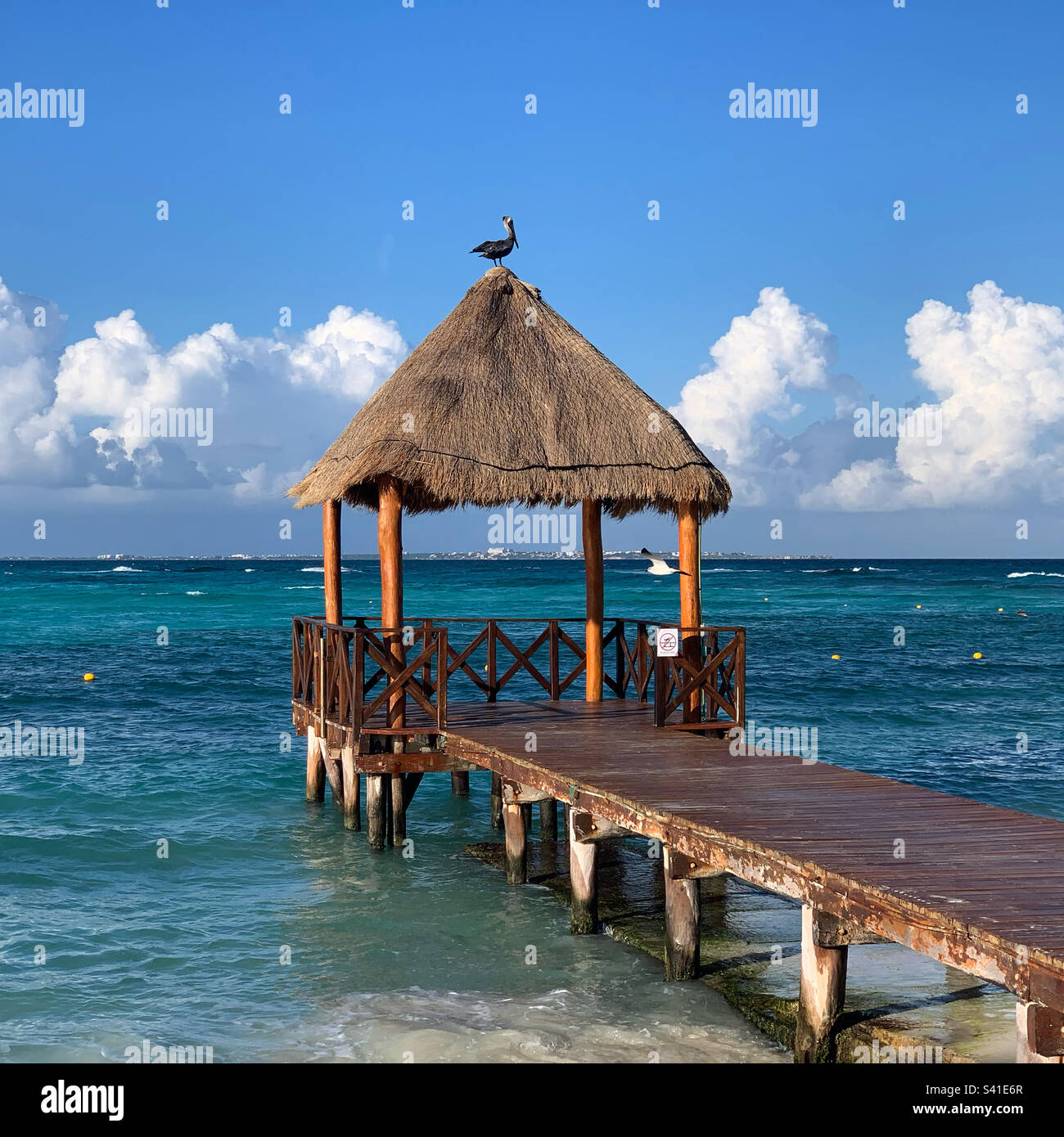 December, 2022, Palapa-covered pier, Punta Cancun, Cancun, Quintana Roo, Mexico - Smartphone Captured Stock Image