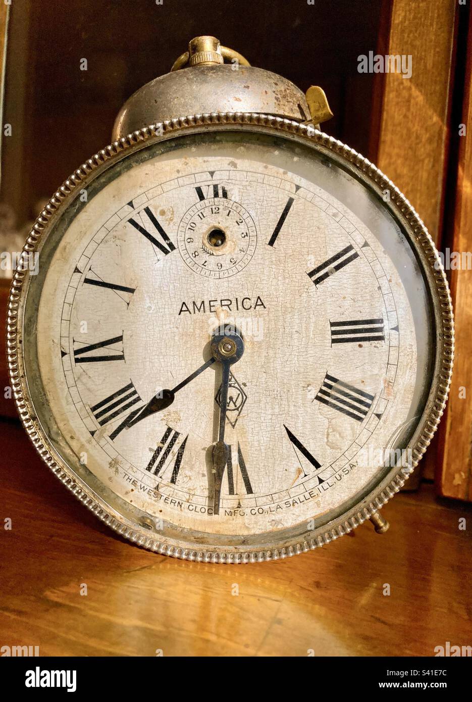 Antique wind up clock with Roman numerals Stock Photo Alamy