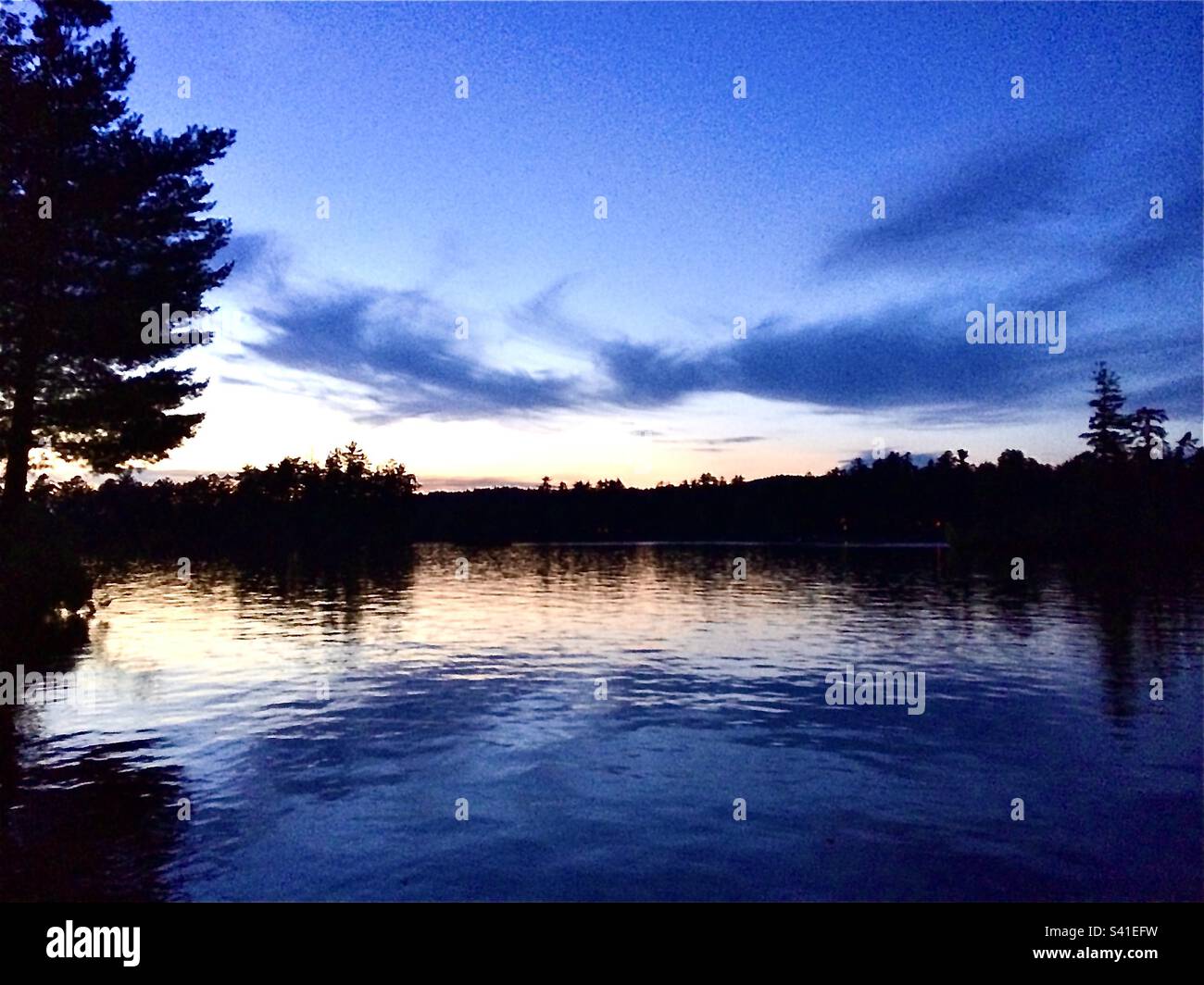 View from water if summer sunset on Pine River Pond, Wakefield, New