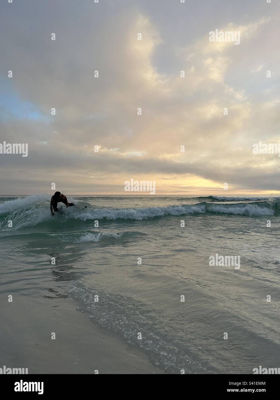 Skim boarding at sunset - Smartphone Captured Stock Image