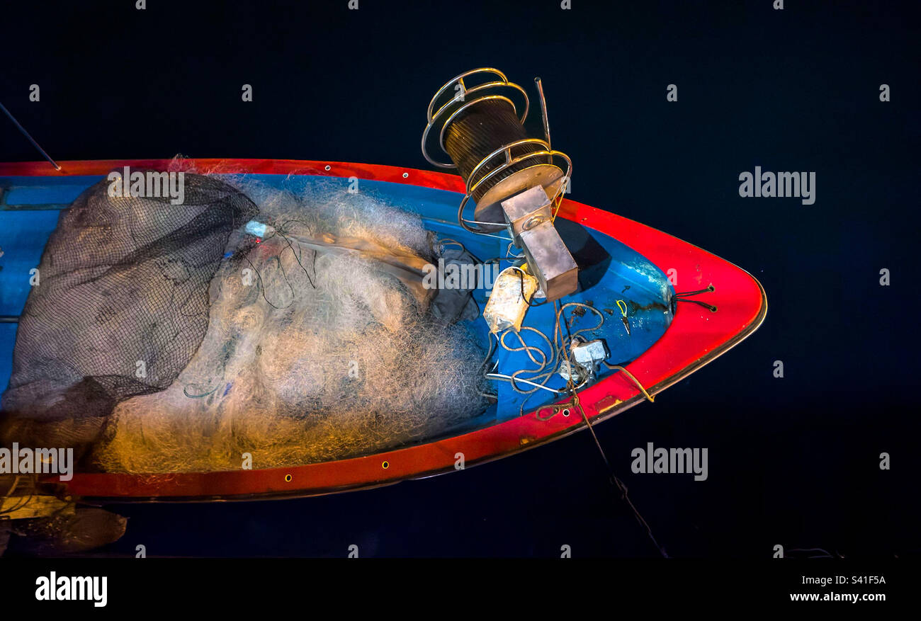 Wooden fishing boat with nets and gear, in the traditional fishing village of Sai Kung, now a district in Hong Kong - Smartphone Captured Stock Image