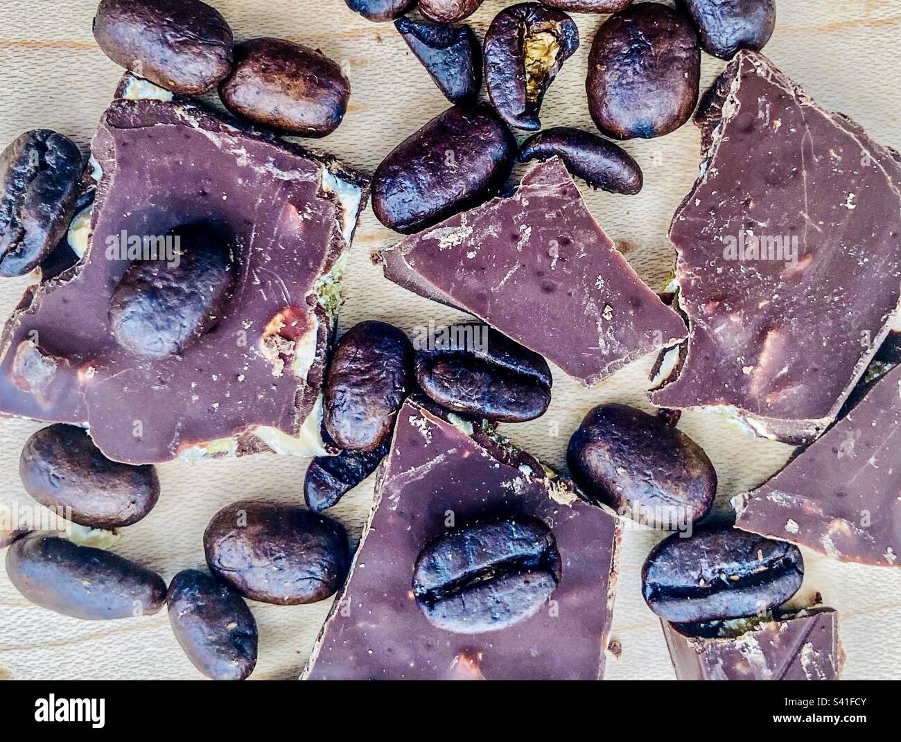 Dark roast coffee beans with pieces of almond chocolate Stock Photo Alamy