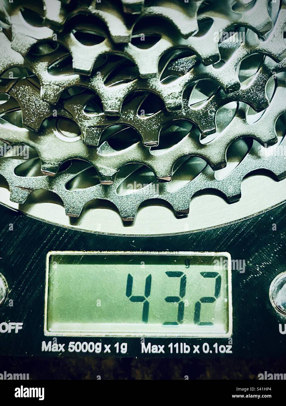 A used bicycle cassette on a kitchen weighing scales - Smartphone Captured Stock Image