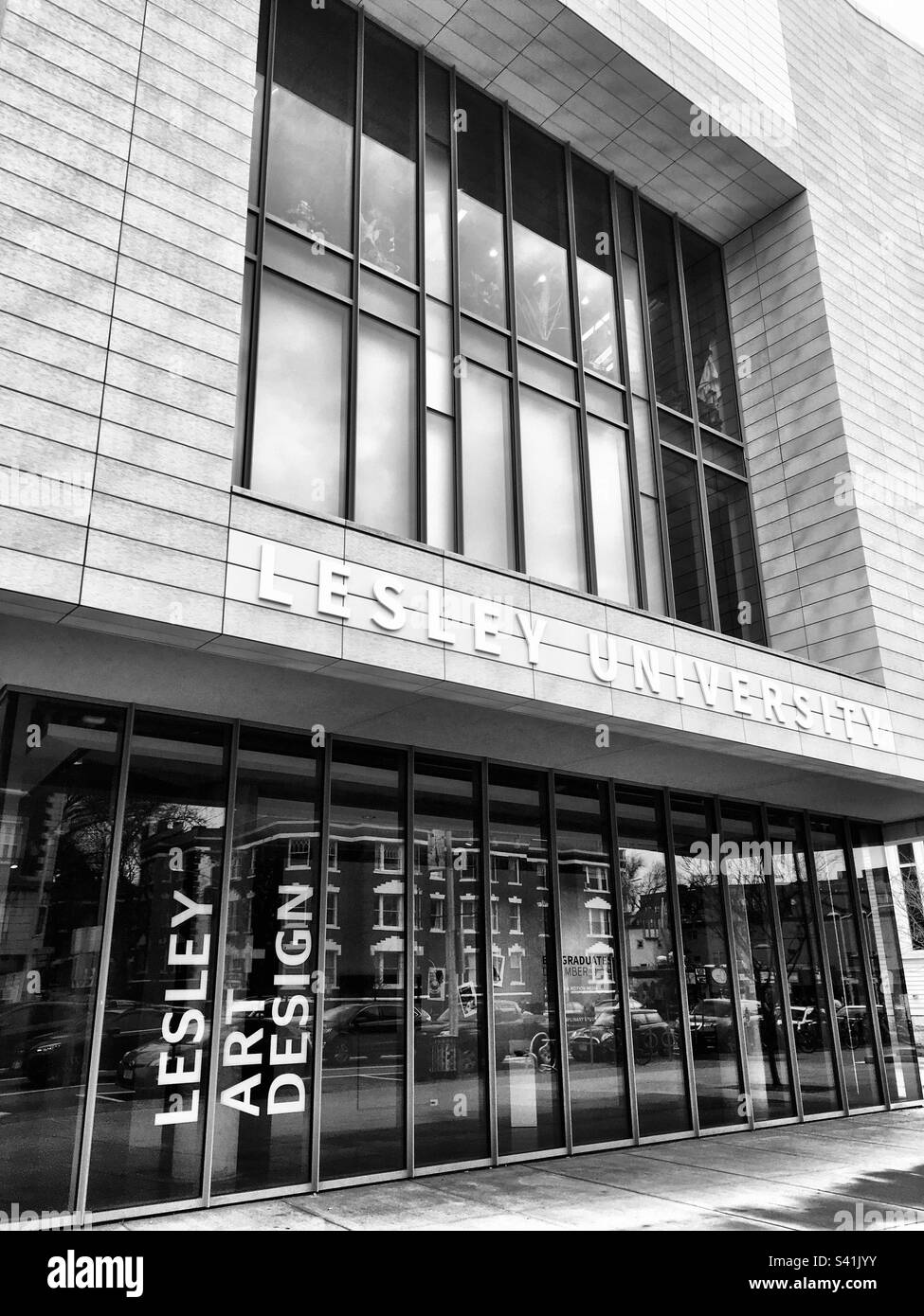 Lesley University on Massachusetts Avenue in Cambridge, MA, USA. Black and white filter. Sign for Lesley Art & Design in the window. - Smartphone Captured Stock Image