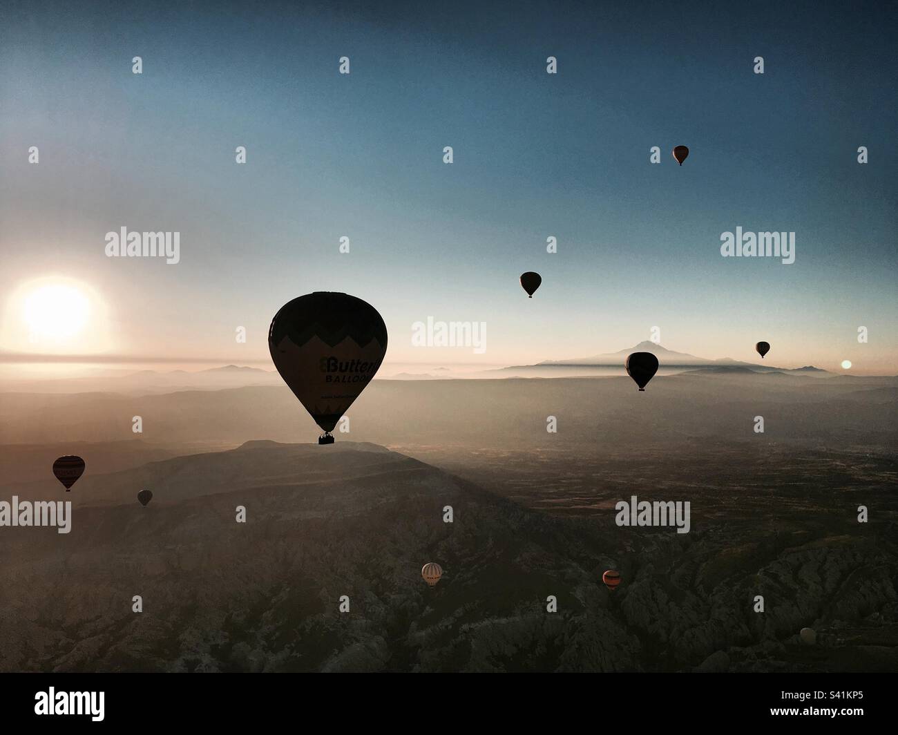 Hot air balloons flying in the sky in Cappadocia (Kapadokya), Turkey (Turkiye) - Smartphone Captured Stock Image Hot air balloons flying in the sky in Cappadocia (Kapadokya), Turkey (Turkiye) - Smartphone Captured Stock Image