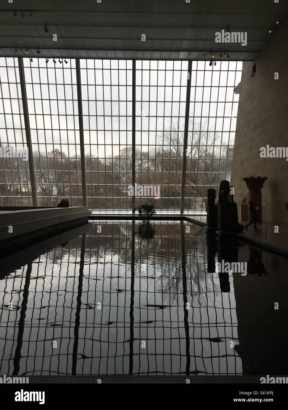 View of grid large window and pond in The Temple of Dendur, Metropolitan Museum of Arts (the MET), Manhattan, New York - Smartphone Captured Stock Image