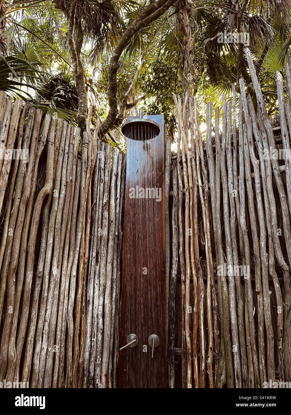 Running water in tropical jungle outdoor shower in Tulum, Mexico Stock
