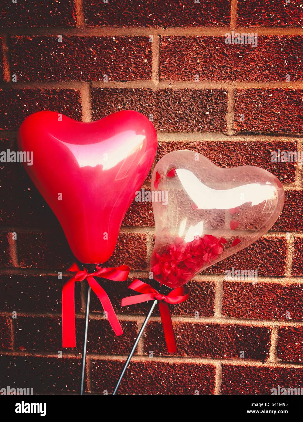 Love heart balloons against a wall - Smartphone Captured Stock Image