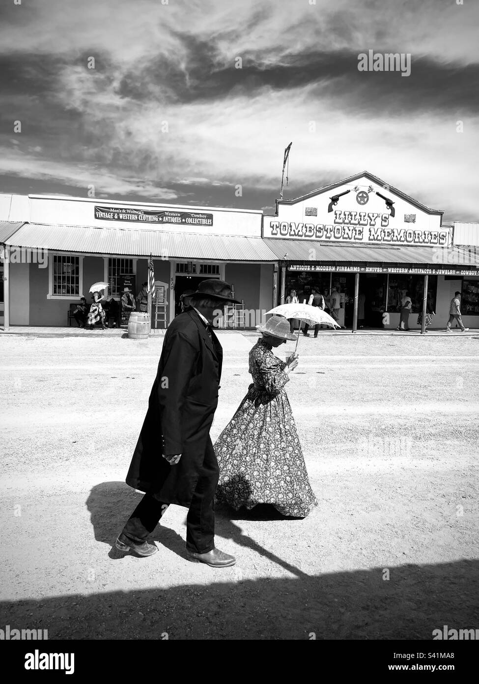 A couple dressed in costume walks down the dirt road. Tombstone, Arizona USA. Stock Photo