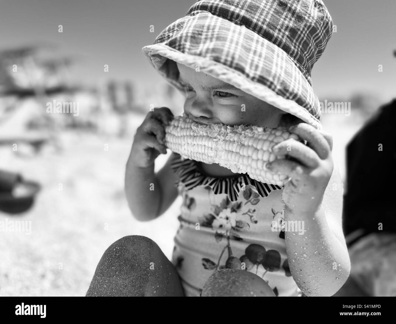 Baby eating corn at the beach Stock Photo Alamy