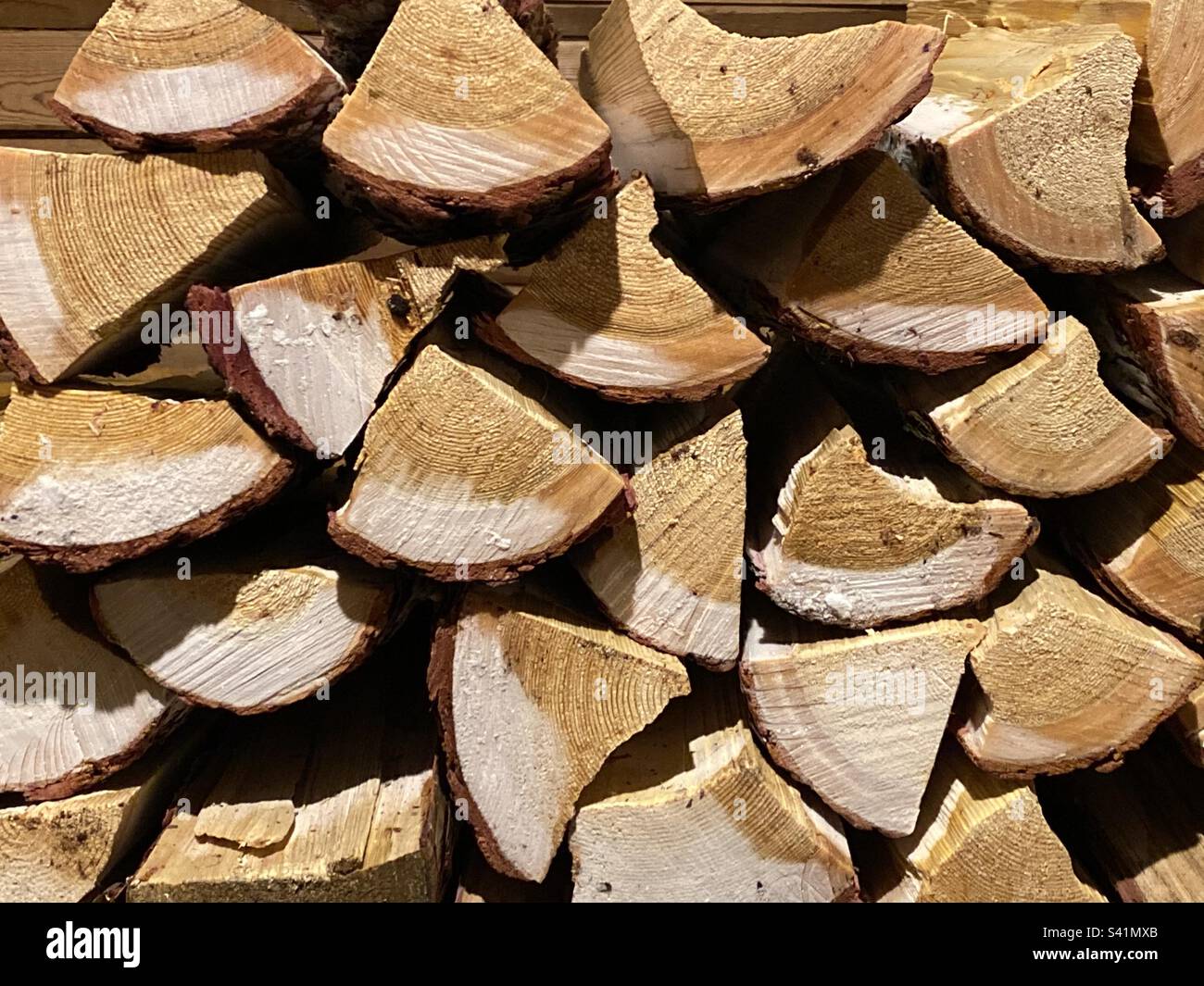 The chopped firewood lies in a stack from the frost and thaws while drying. - Smartphone Captured Stock Image