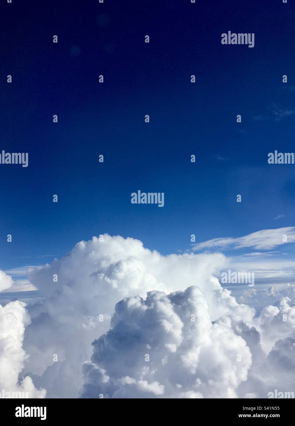 Puffy white clouds against a blue sky Stock Photo - Alamy
