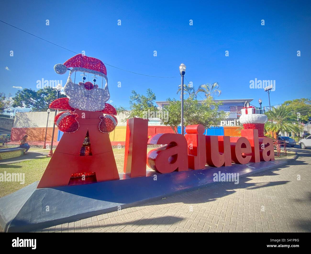 A large Alajuela sign with a Santa Claus figure at the beginning in Costa Rica - Smartphone Captured Stock Image
