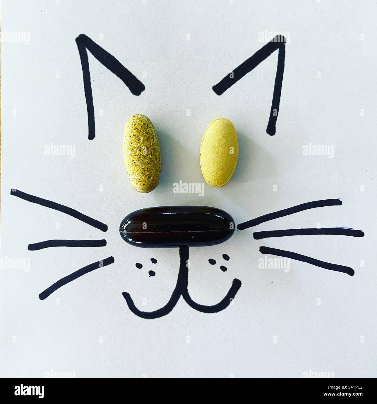 Daily vitamins with cat face - Smartphone Captured Stock Image