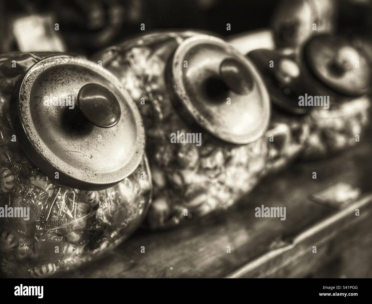 Antique candy jars on a wooden counter in an old general store - Smartphone Captured Stock Image