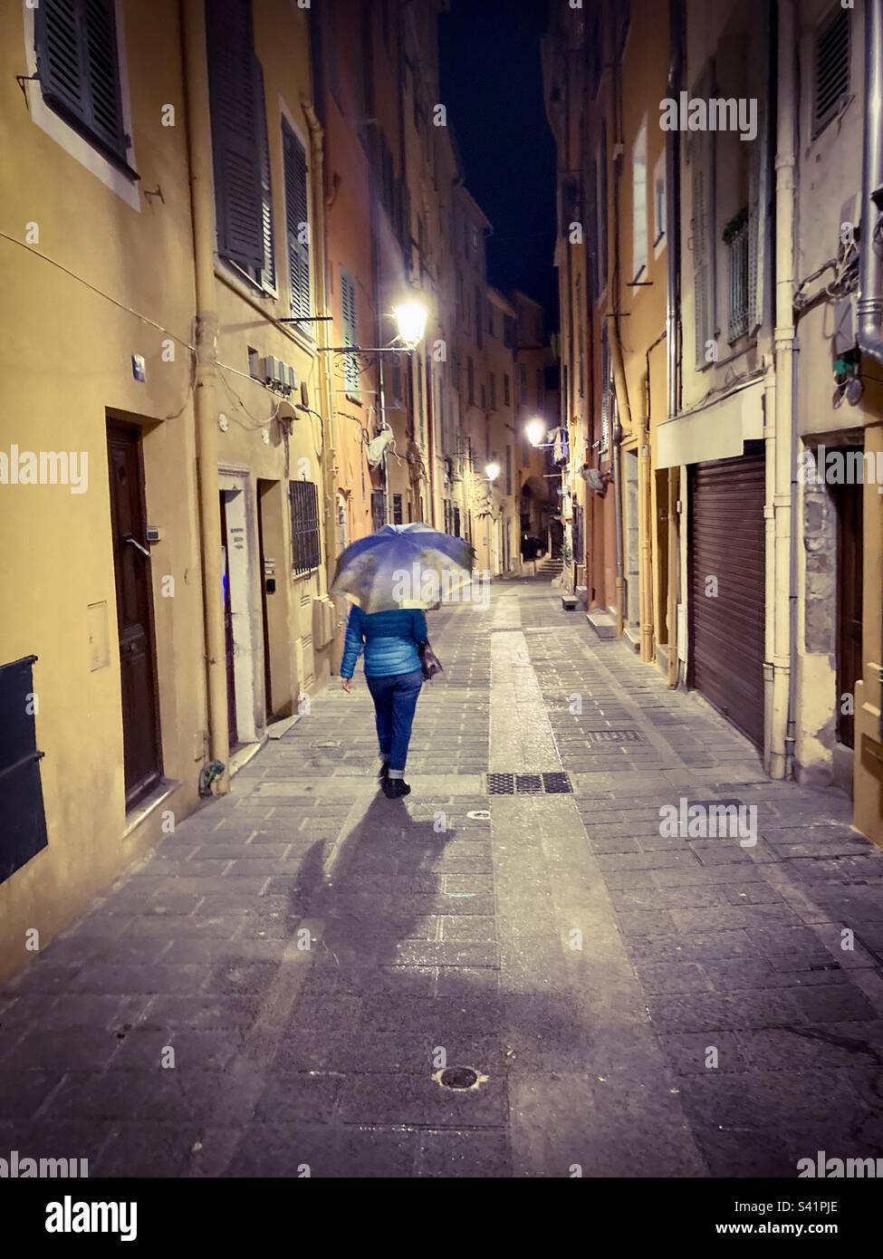 Walking through the old town of Menton, France on a rainy spring evening. - Smartphone Captured Stock Image