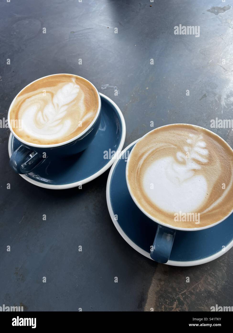 Delicious lattes with beautiful foam art Stock Photo Alamy