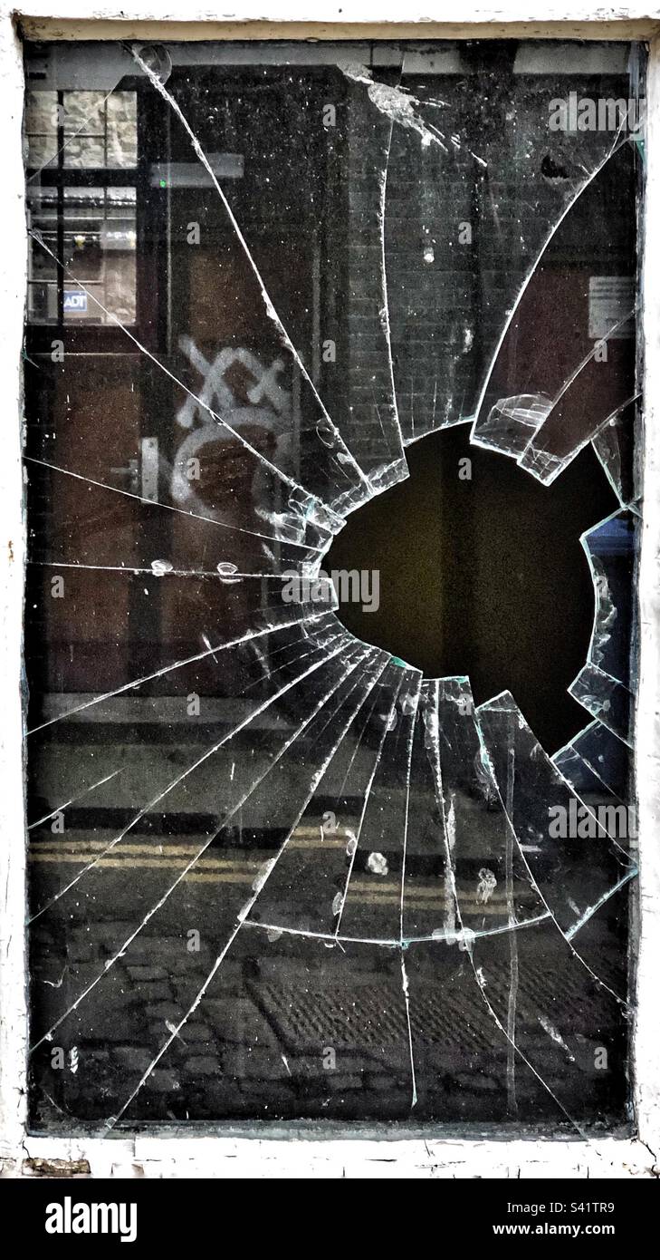 Broken window pane in alleyway - Smartphone Captured Stock Image