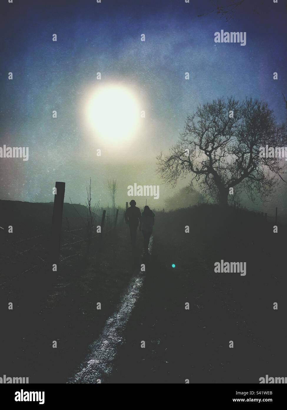 Two people in silhouette on a country pathway - Smartphone Captured Stock Image