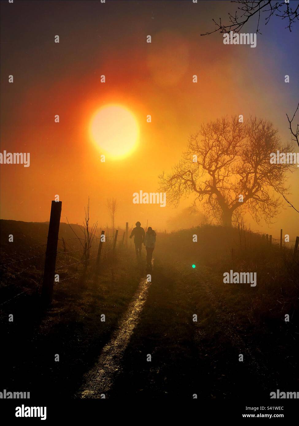 Two people walking on a country walkway - Smartphone Captured Stock Image