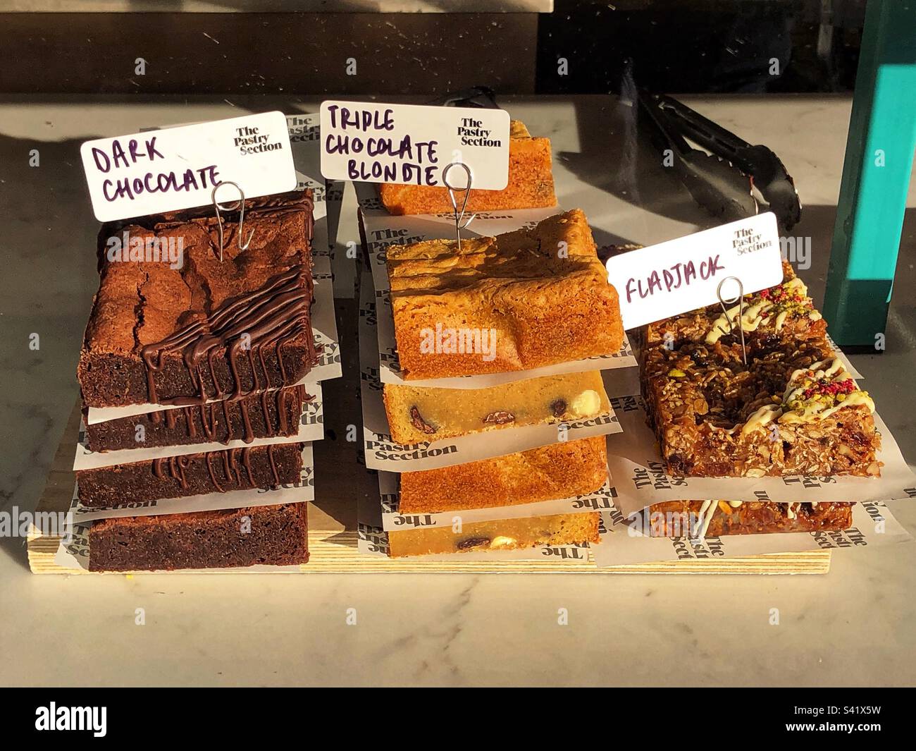 Cake selection in bakery shop window Stock Photo - Alamy