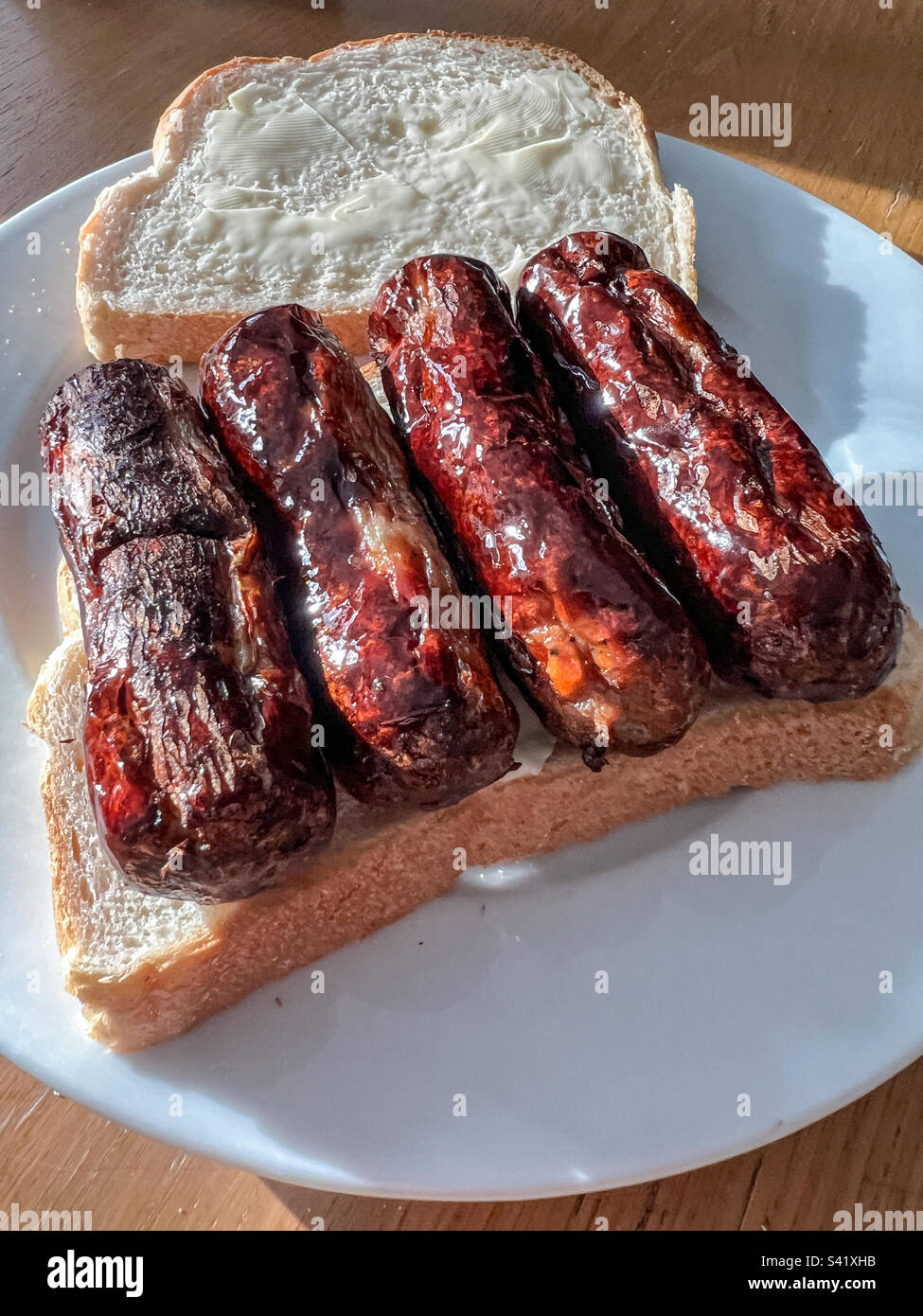 Sausage sandwich on white bread Stock Photo Alamy