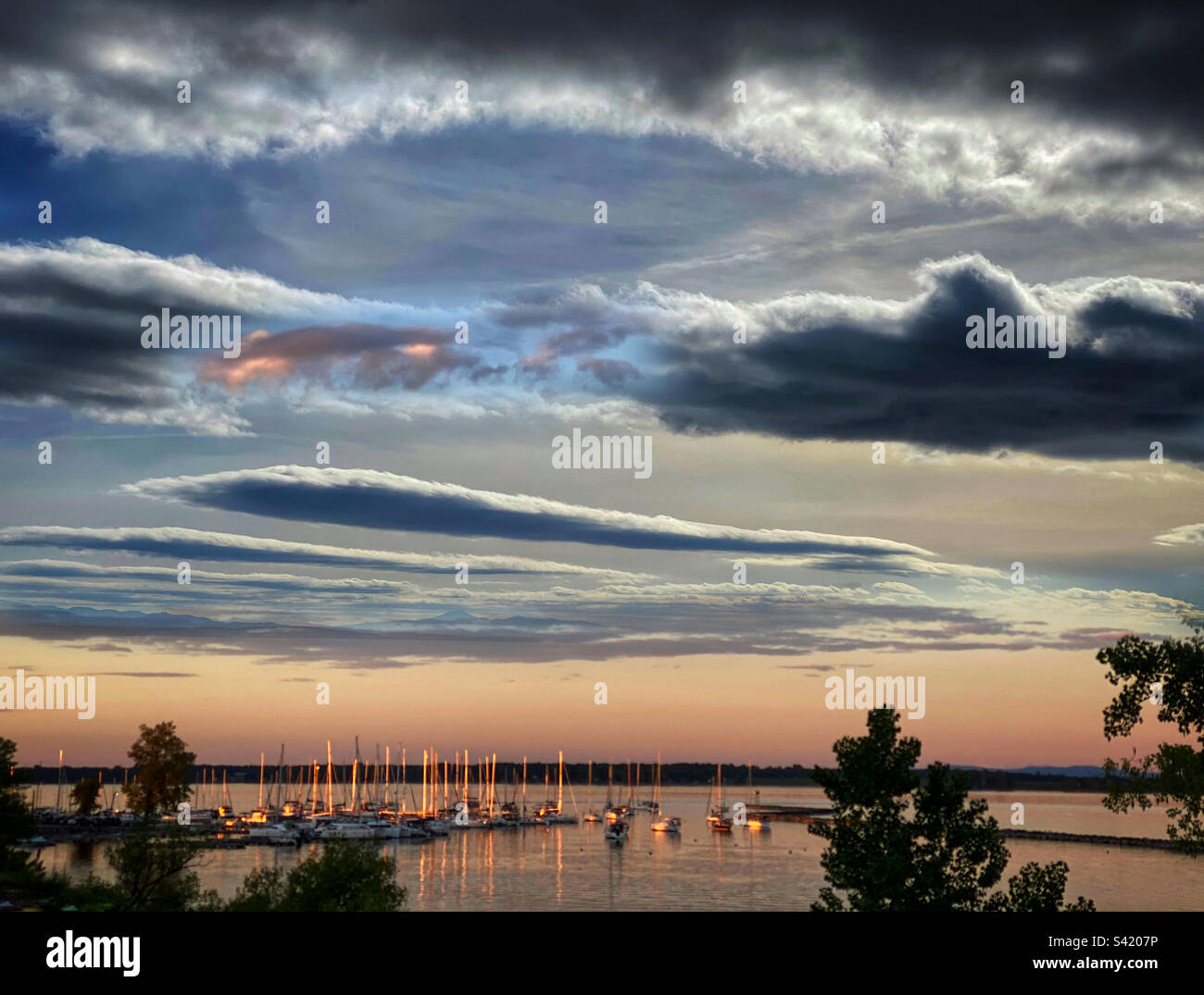 Sailboats in a safe harbor at sunset - Smartphone Captured Stock Image