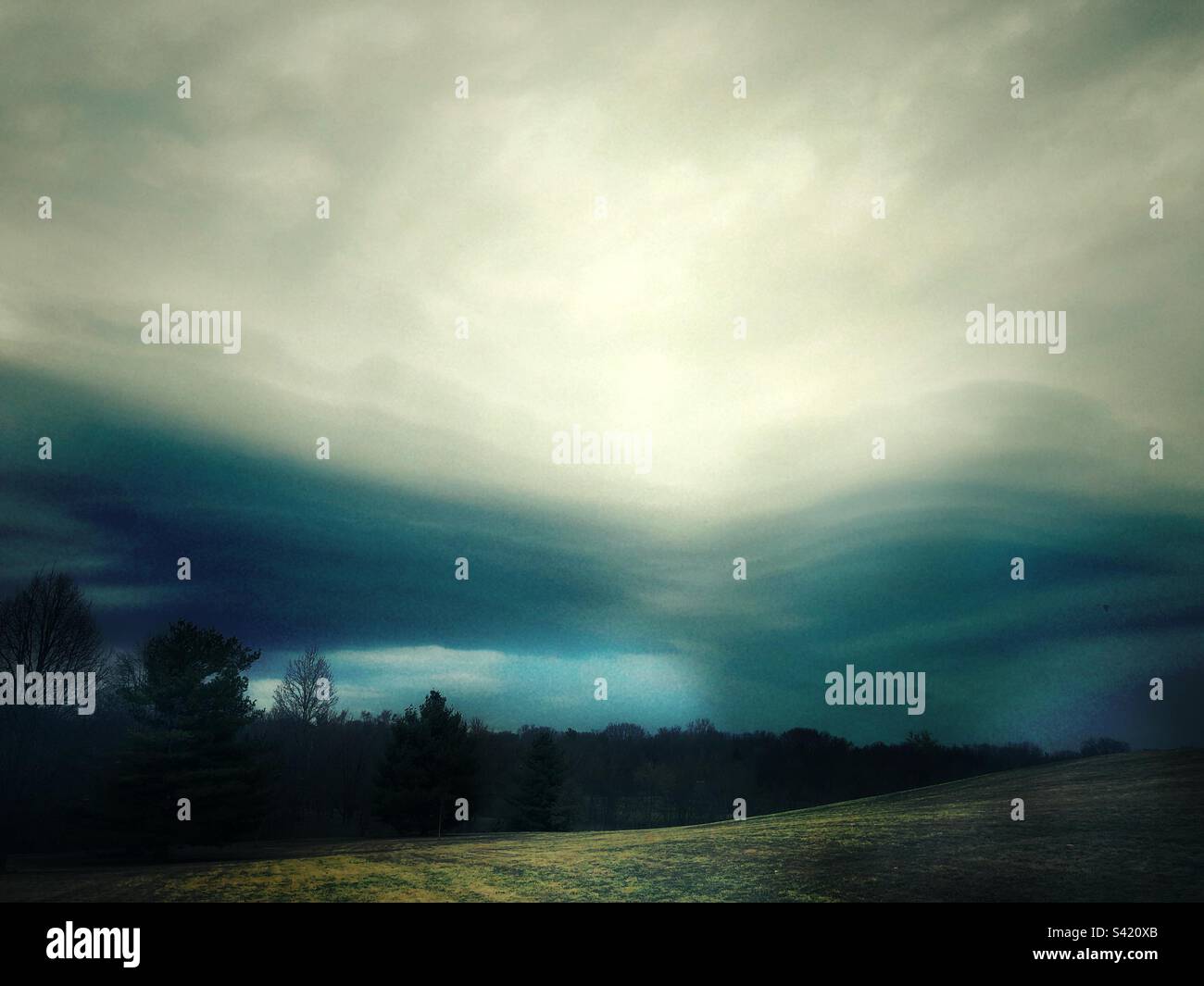 Stormy weather, dark, gloomy, dramatic clouds passing by. - Smartphone Captured Stock Image Stormy weather, dark, gloomy, dramatic clouds passing by. - Smartphone Captured Stock Image