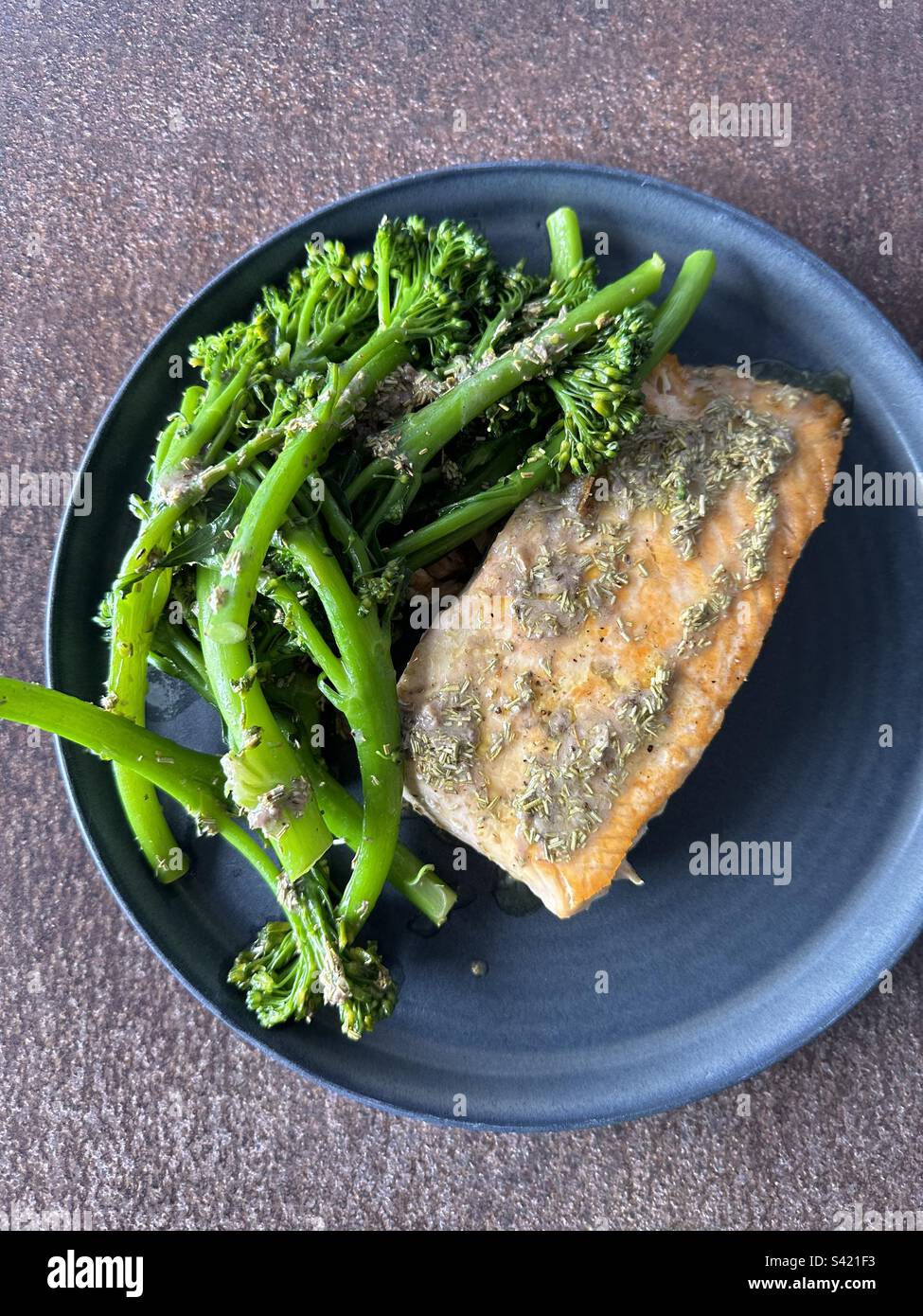 Salmon with broccolini and anchovies, lemon and rosemary sauce Stock Photo Alamy