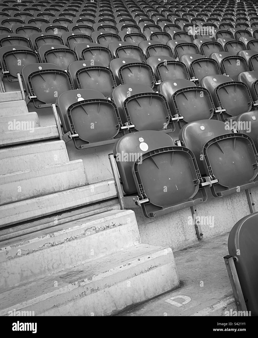 ‘Plenty of room’ rows of empty seats at the end of the game on match day (Black & White). Stock Photo