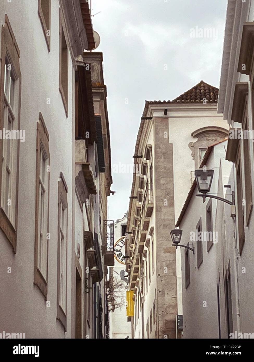 Narrow streets of old town Tavira with the clock tower in partial view - Smartphone Captured Stock Image
