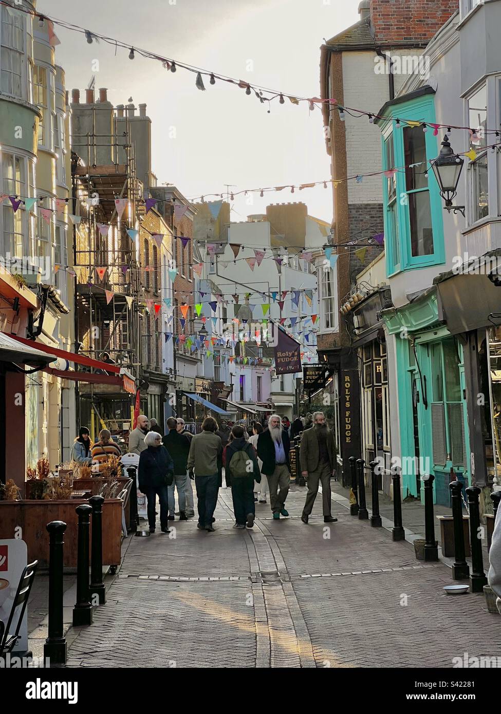 Pedestrians shopping and browsing on street in Hastings Old town