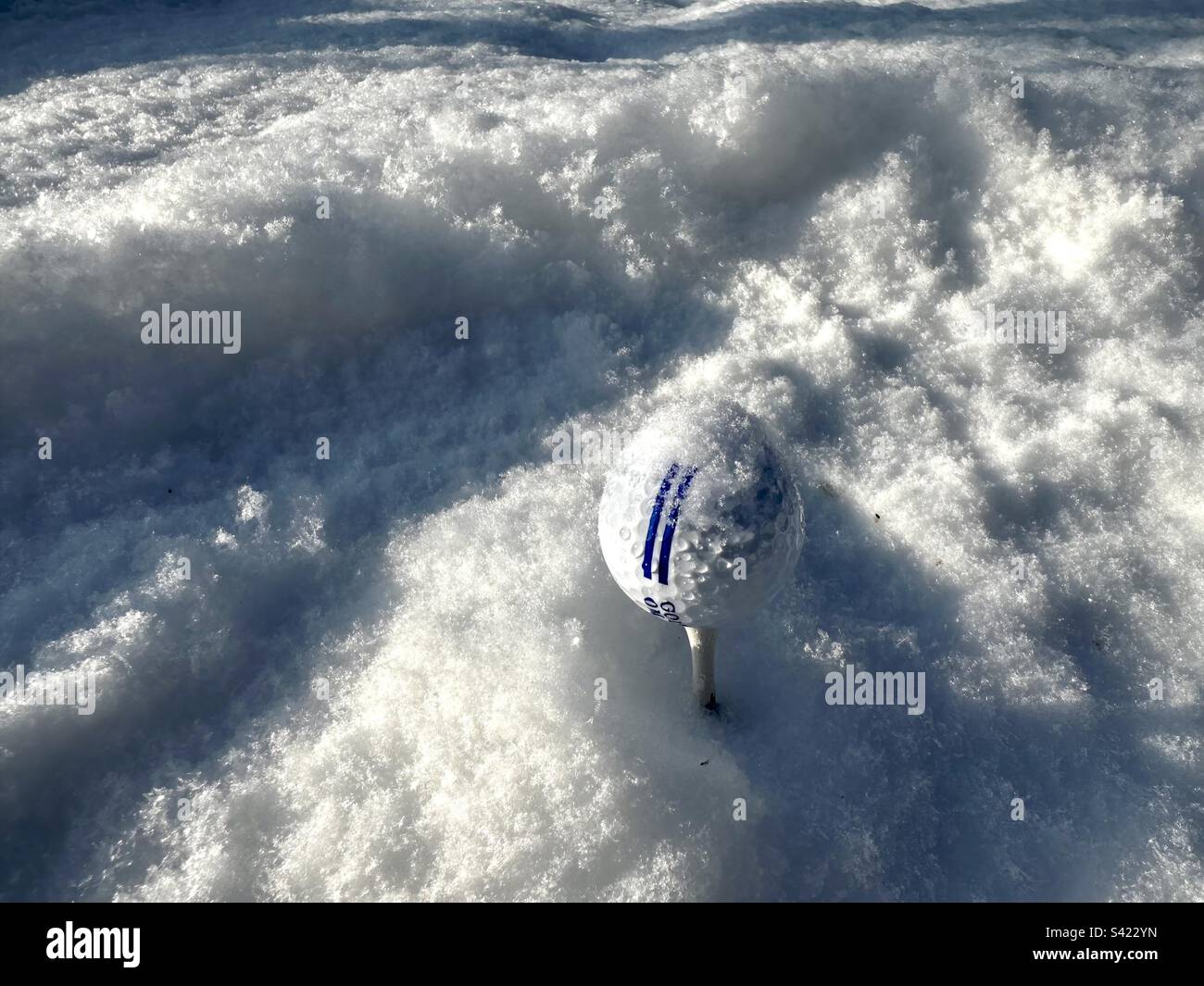 Golf ball in snow - Smartphone Captured Stock Image