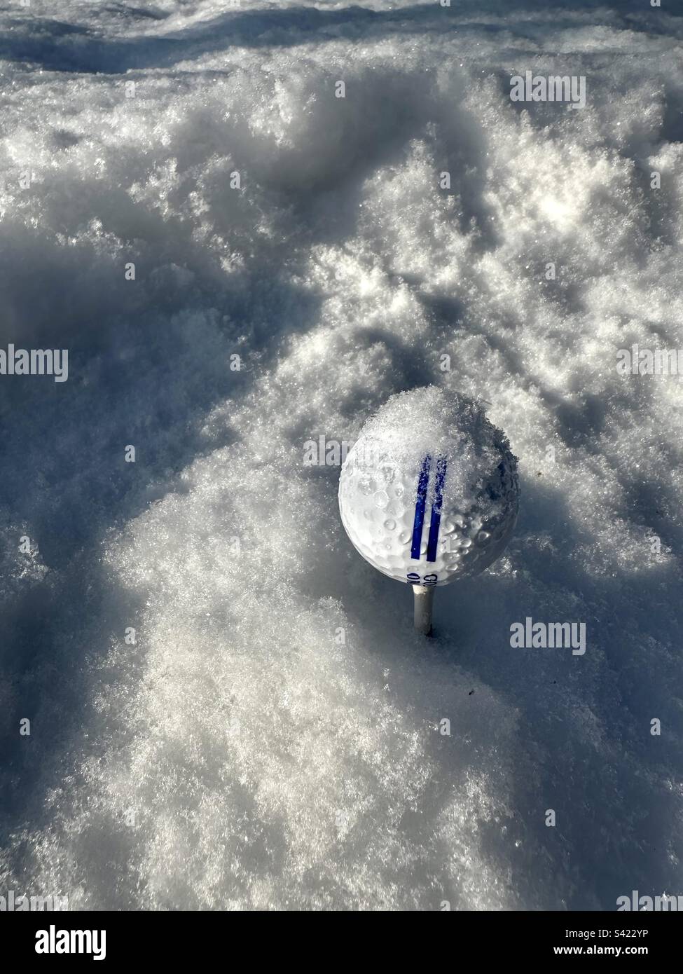Golf ball in snow - Smartphone Captured Stock Image