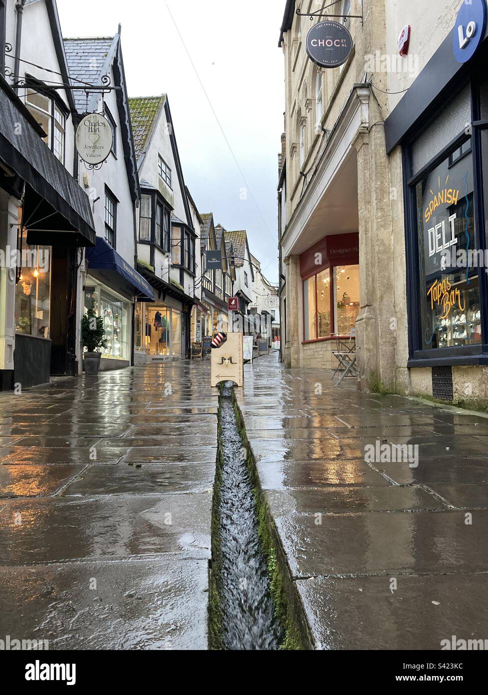 Old street in Frome, Somerset with a stream running down the middle Stock Photo
