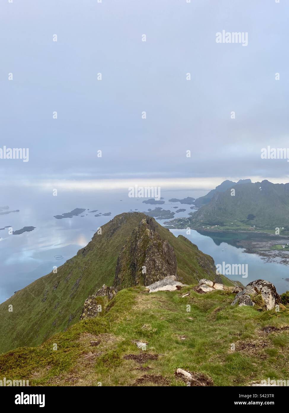 View from the Kylpesnestinden in Lofoten islands, you can see Tatinden in the foreground and some smaller islands down in the sea. - Smartphone Captured Stock Image