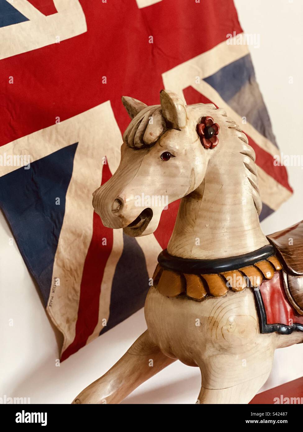 Rocking horse in front of vintage flag - Smartphone Captured Stock Image