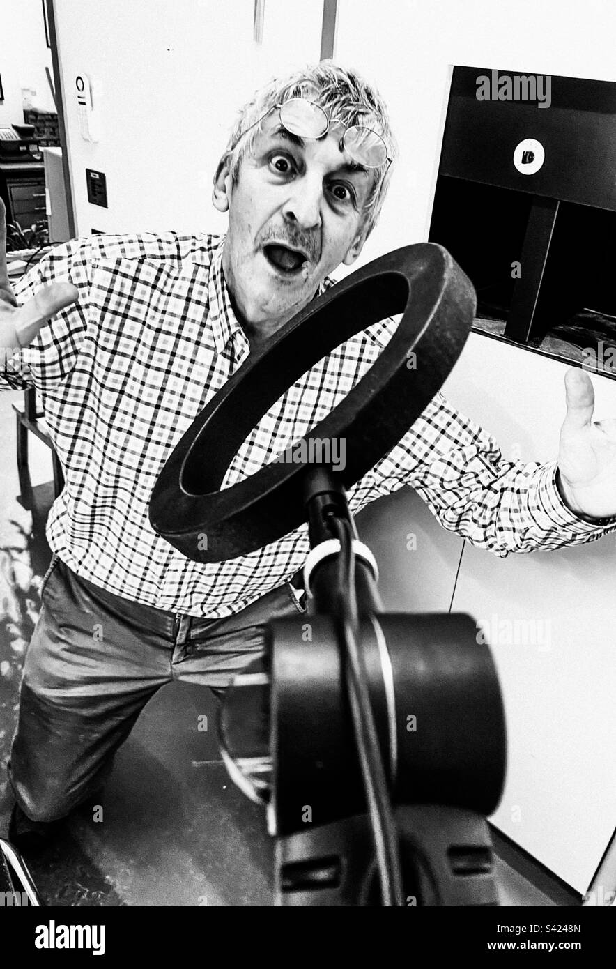 An older man makes a funny shape for the camera - Smartphone Captured Stock Image