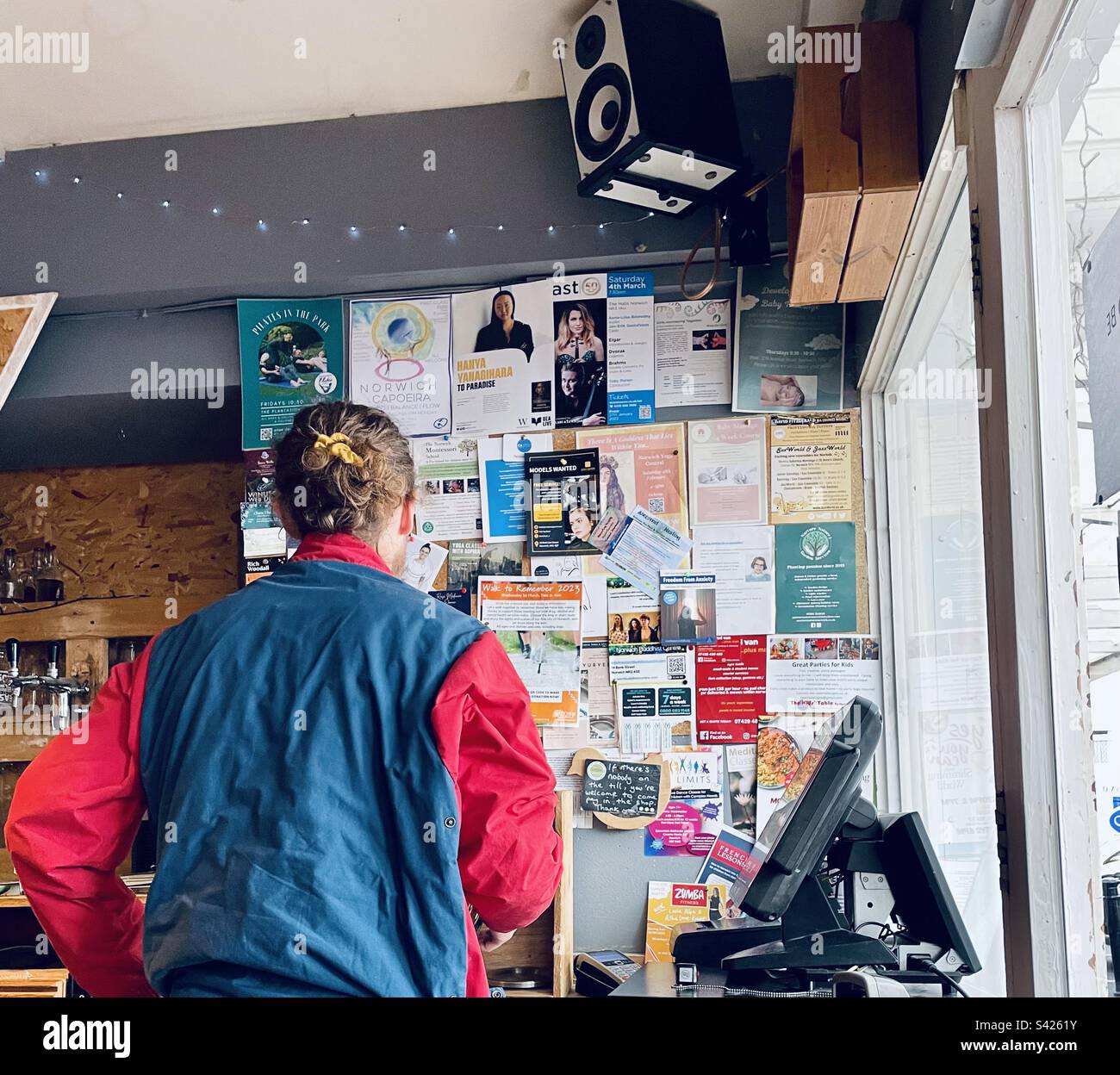 A man looking at local cafe area notice board. Stock Photo