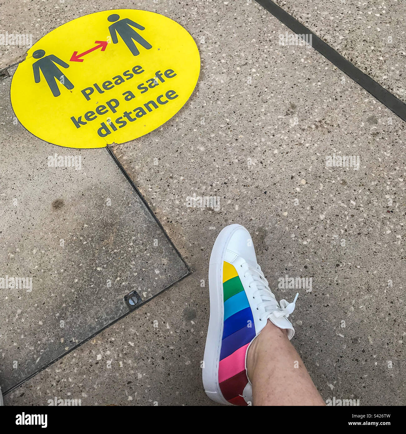 Woman’s foot by a Covid distance sign - Smartphone Captured Stock Image