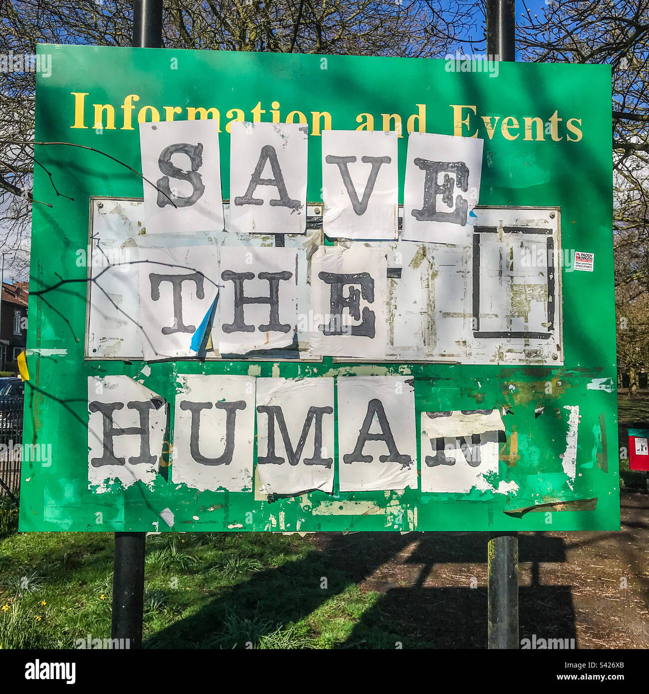 Save the human sign at a local park gate - Smartphone Captured Stock Image