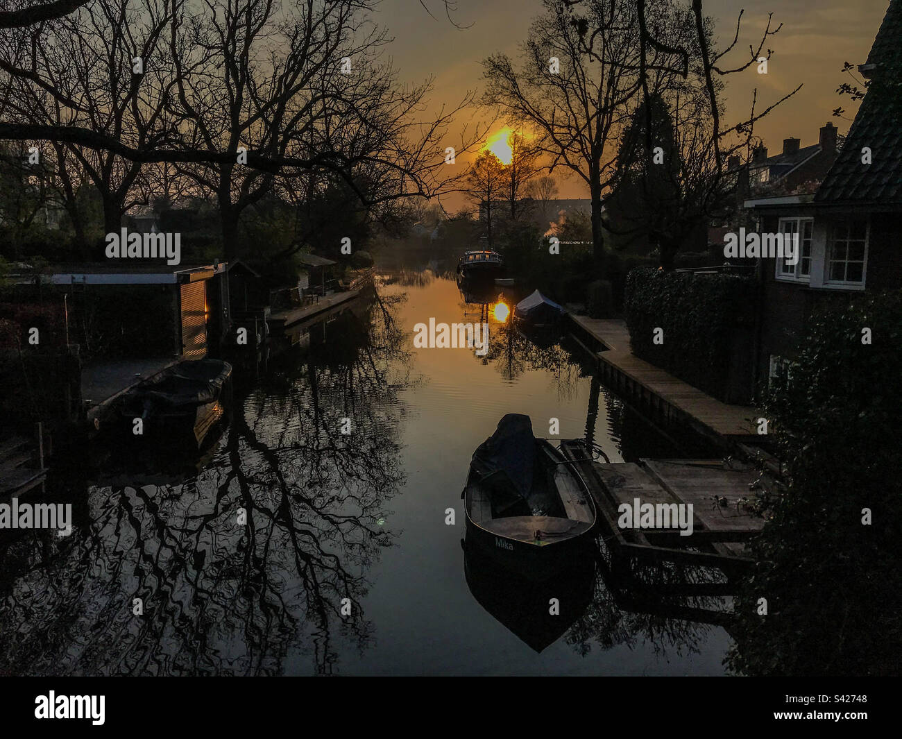 A stunning sunrise's reflection creates a peaceful and picturesque scene - Smartphone Captured Stock Image