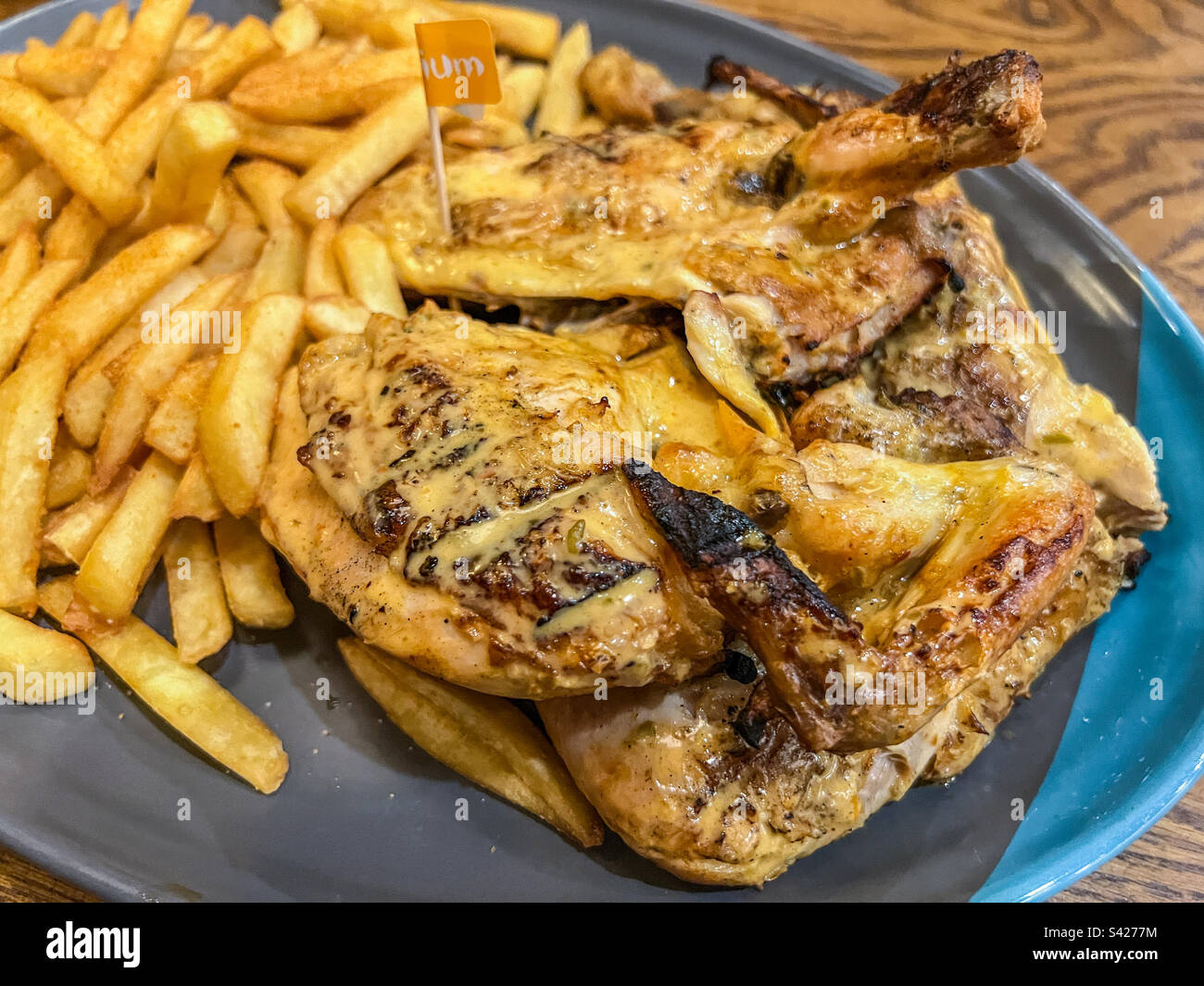 Nando’s whole peri peri chicken and seasoned chips Stock Photo