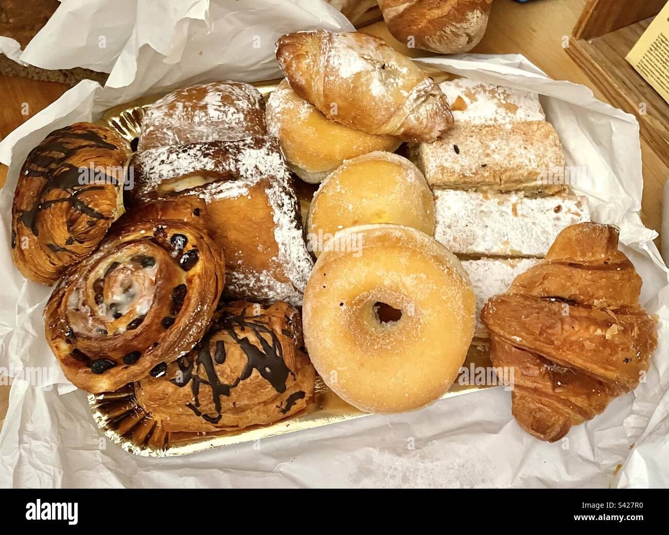 Different types of cakes and pastries like donuts and brioches Stock