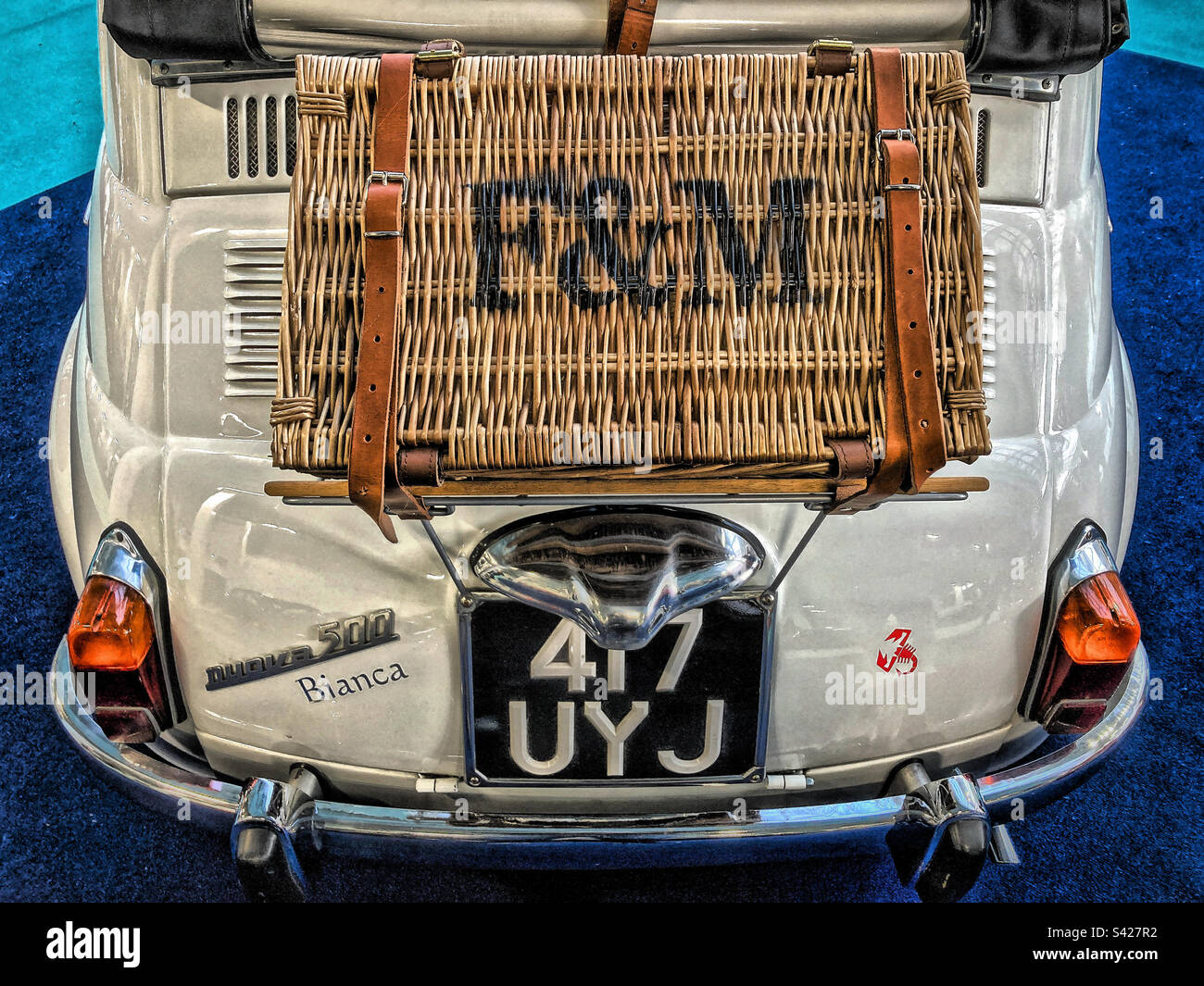 Fortnum and Masons Wicker Hamper on the back of a classic  White, 1961, Convertible, Fiat 500 - Smartphone Captured Stock Image
